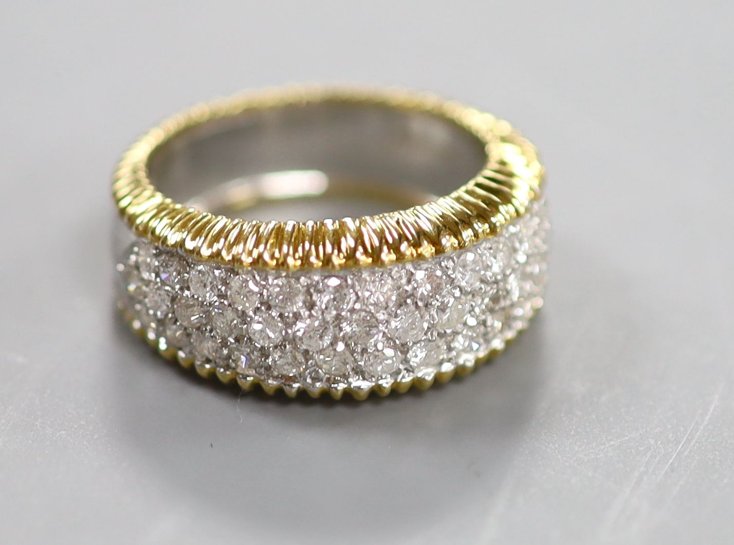 A modern 18ct gold and pave set diamond dress ring